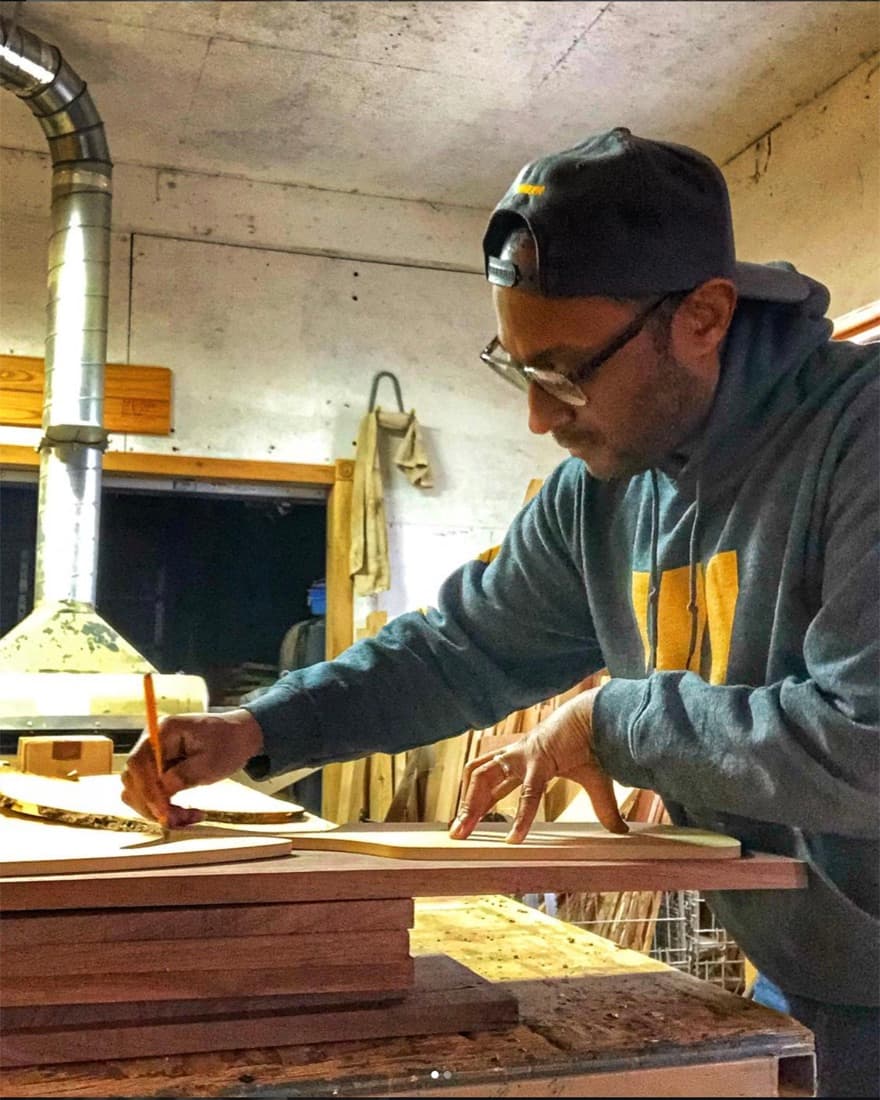 Steve Larosiliere marking a slab at the bench in the Purpose Wood Co. shop